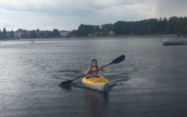 Girl kayaking in the rain